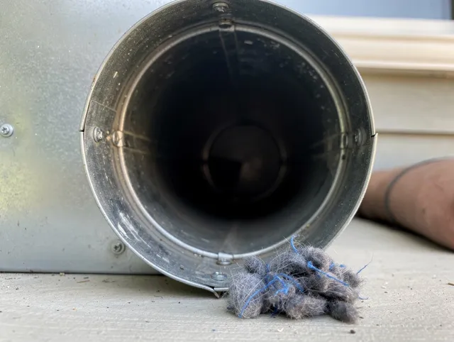 Sagamore Hills Dryer Vent Cleaning technician using specialized equipment to clear severe dryer vent blockage in Sagamore Hills